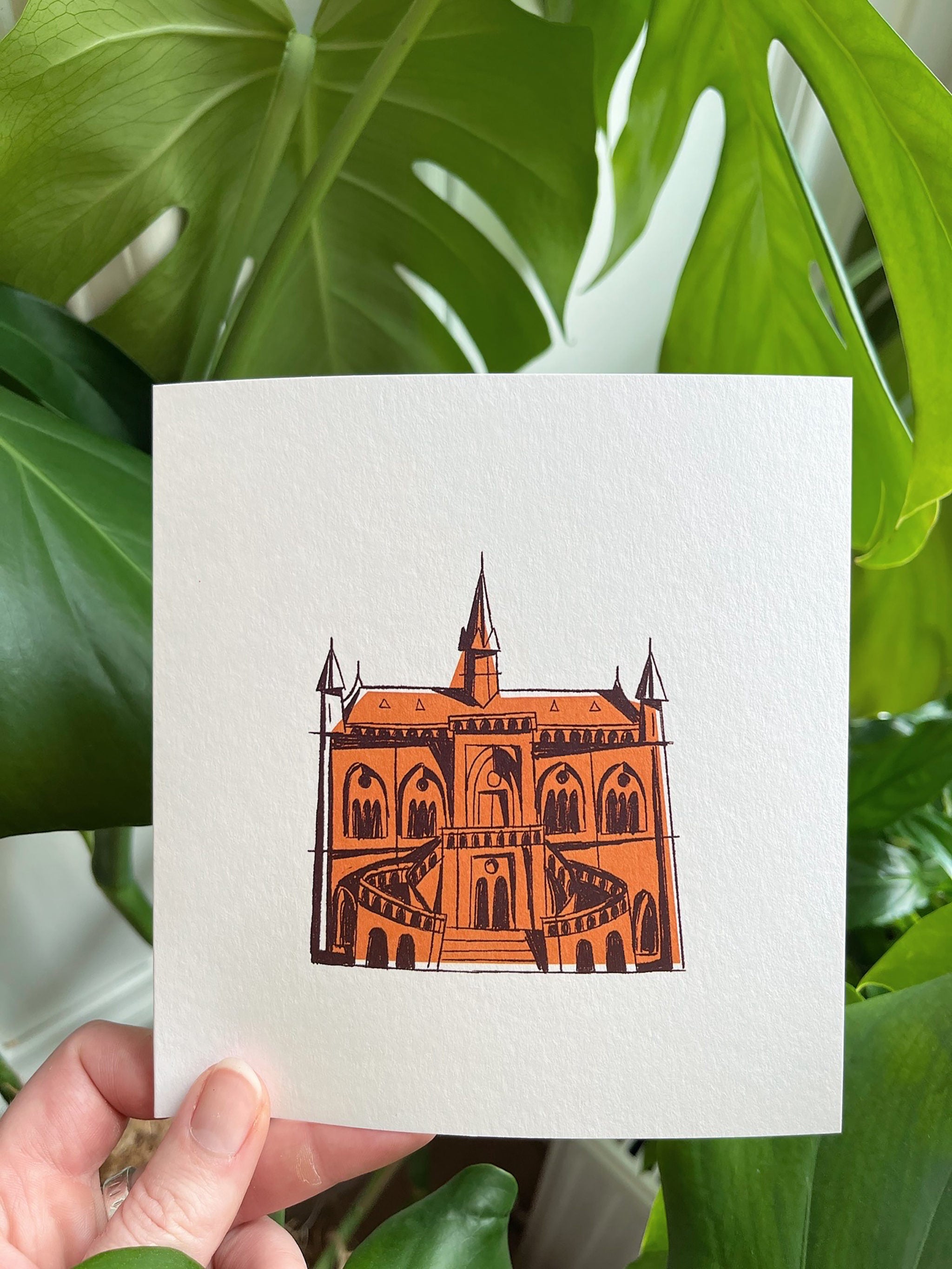 McManus Gallery greeting card -- card with a brown illustration of a 'castle' held against a green leafy background.