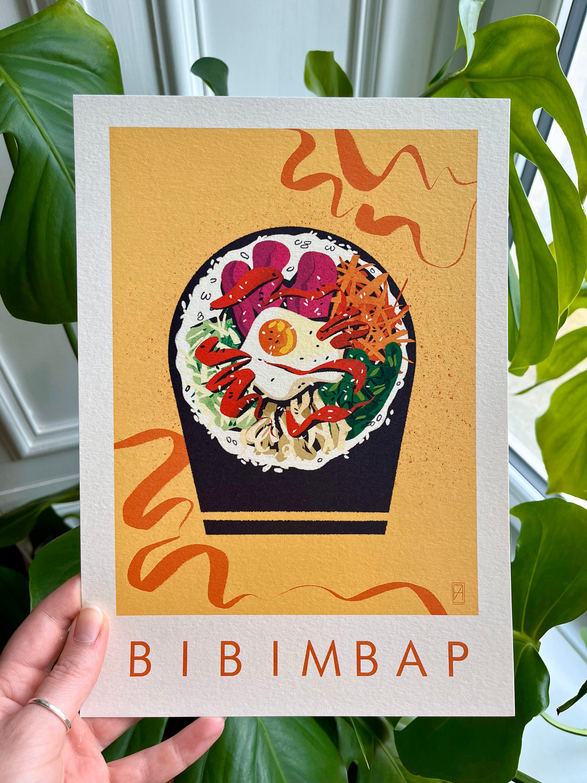Bibimbap print -- hand-held A4 print of bibimbap.